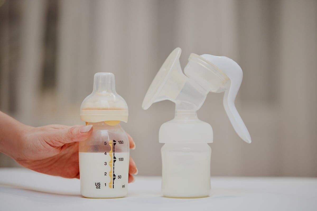 Breast Pump and Bottle with Milk for Baby